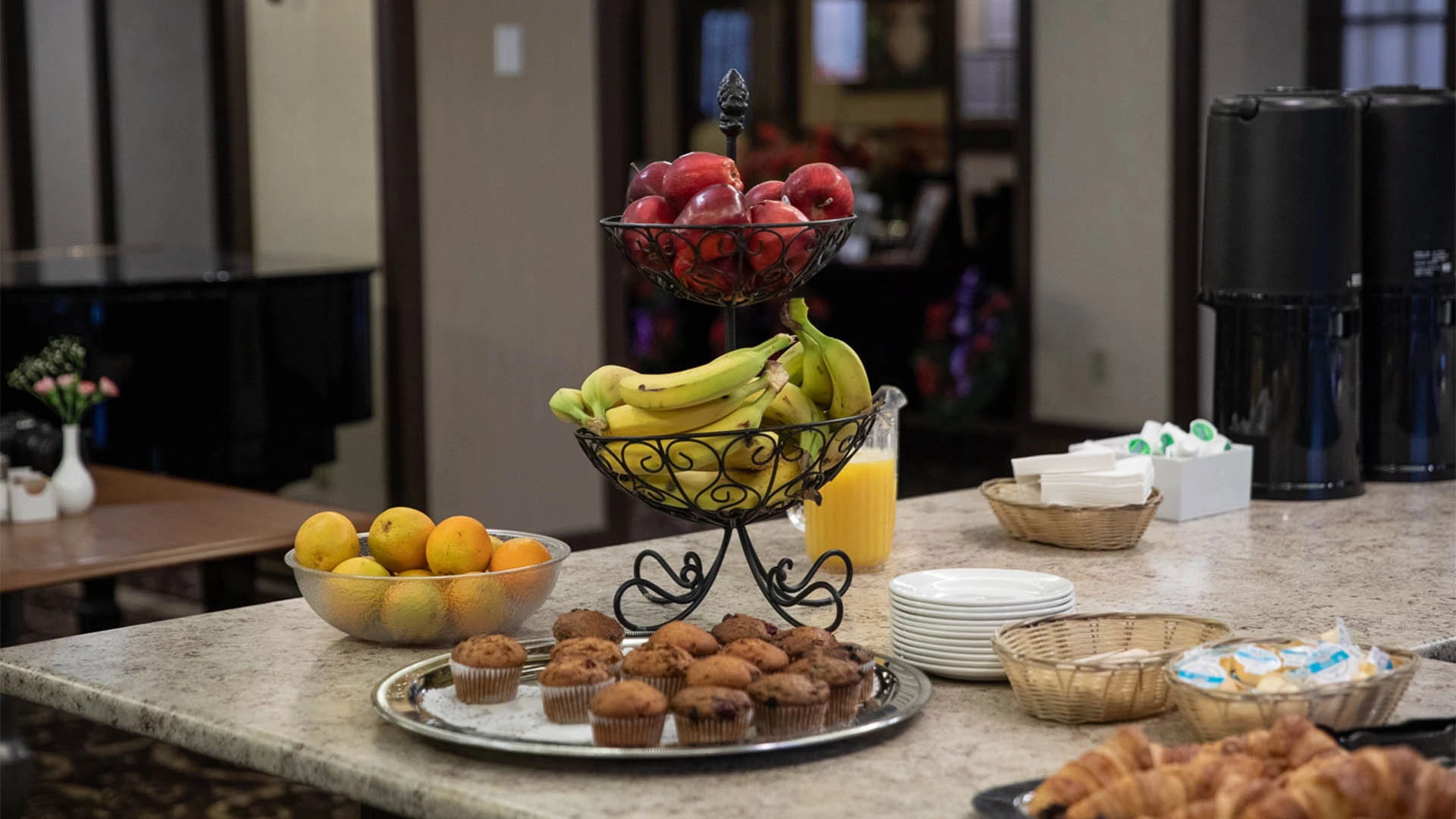 Fruits and muffins on corner of a counter top