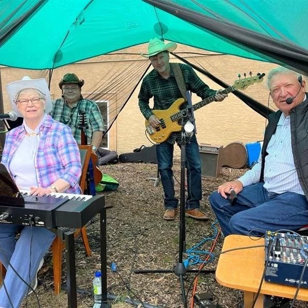 Musical performance featuring keys, vocals, guitar, and bass.